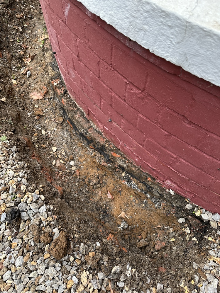 a trench showing the base of a building