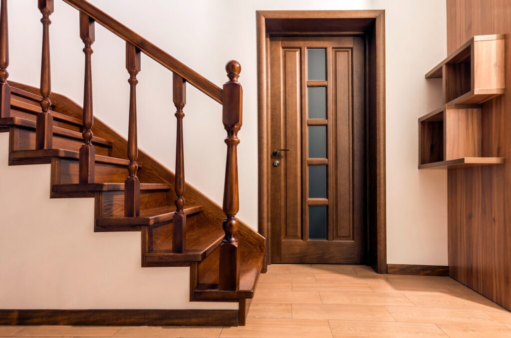 Modern brown oak wooden stairs and doors in new renovated house interior